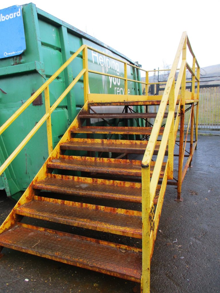 A man was injured when he manually moved steps weighting in excess of 950kg at a recycling plant.