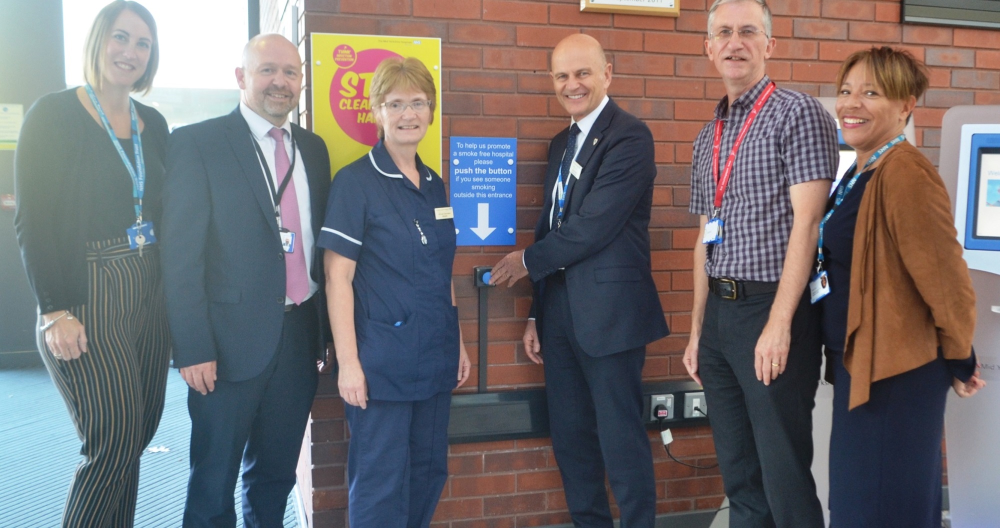 Out for a crafty fag - no Iain Brodie, General Manager of Facilities and colleagues stand by the blue button at Pinderfields Hospital which when pressed will cause smokers to be shouted at to put their cigarettes out