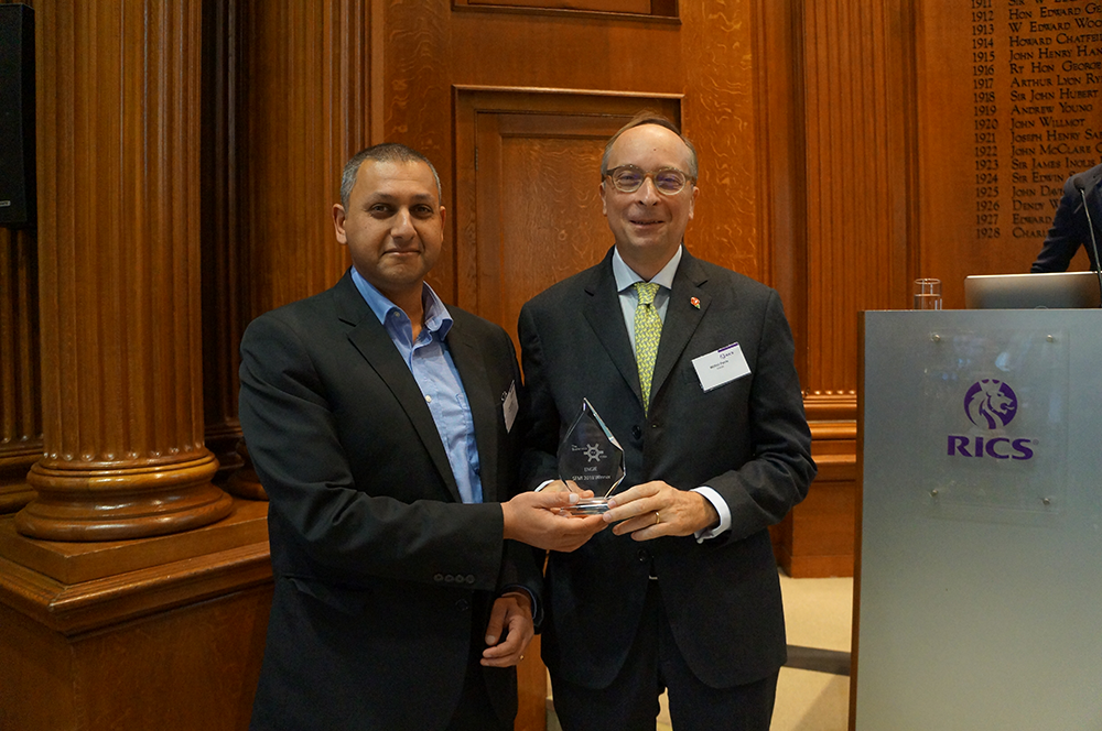 Sunil Shah Acclaro/SFMI MD (left) presenting the award to Wilfrid Petrie, CEO, Engie UK & Ireland.