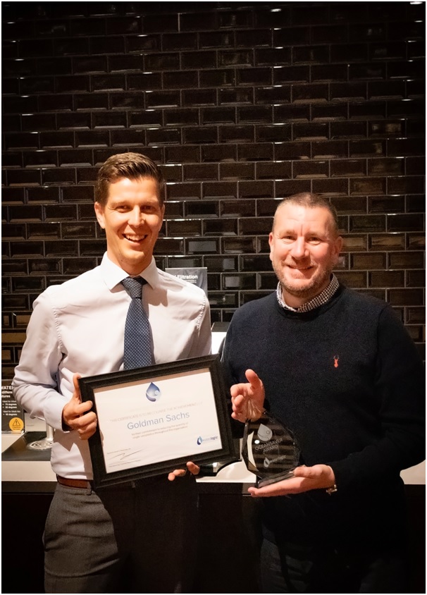 Matt Hemming, Customer Experience Director at Waterlogic UK, presents Dean Tracey, Executive Director in Hospitality Operations at Goldman Sachs, with the Oceansaver Accolade